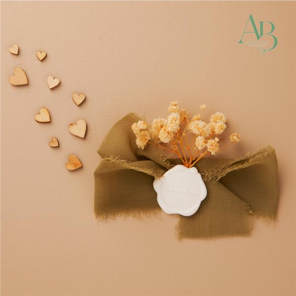 Applicazione con fiocco chiffon di colore verde e ceralacca